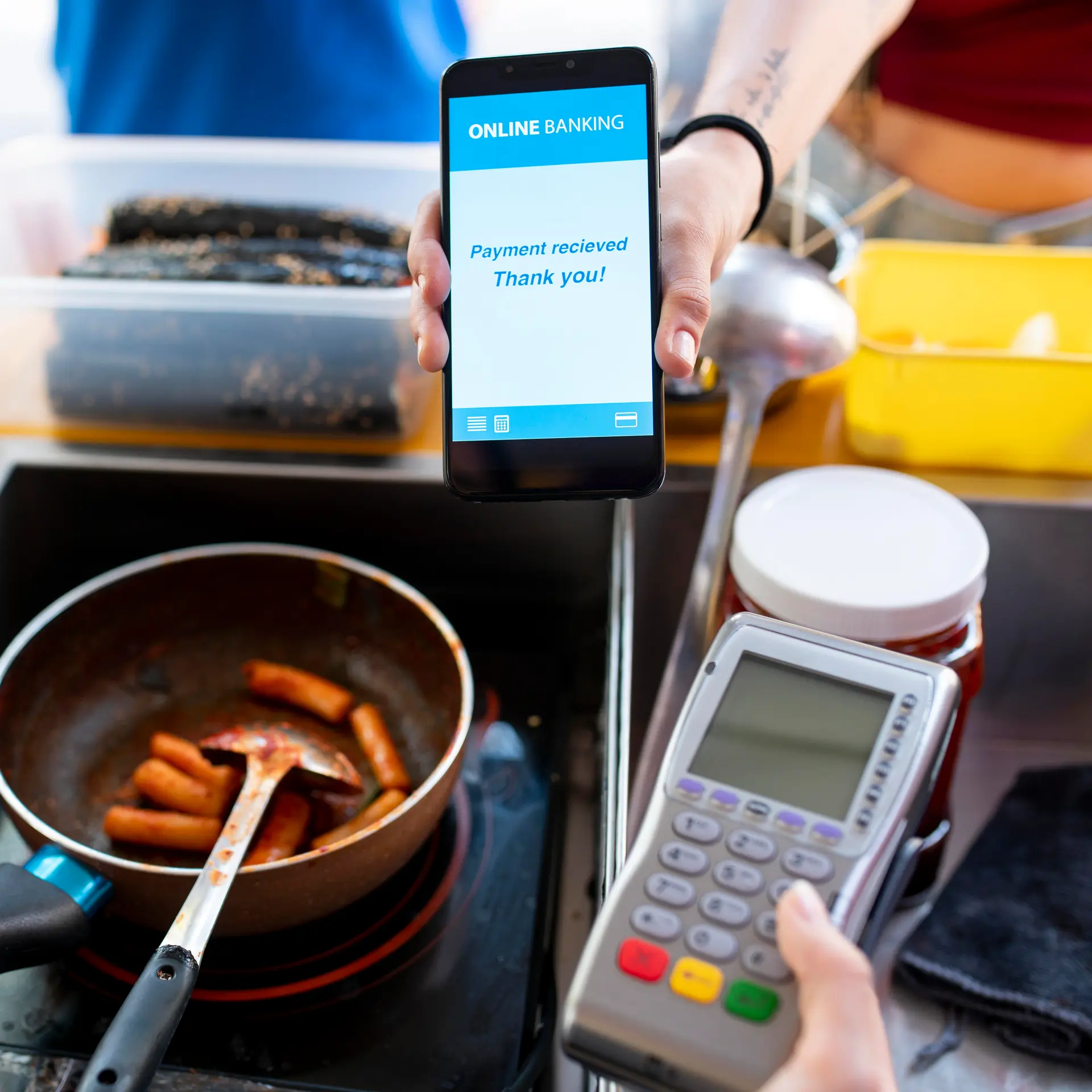 Guest holding a phone to settle the bill