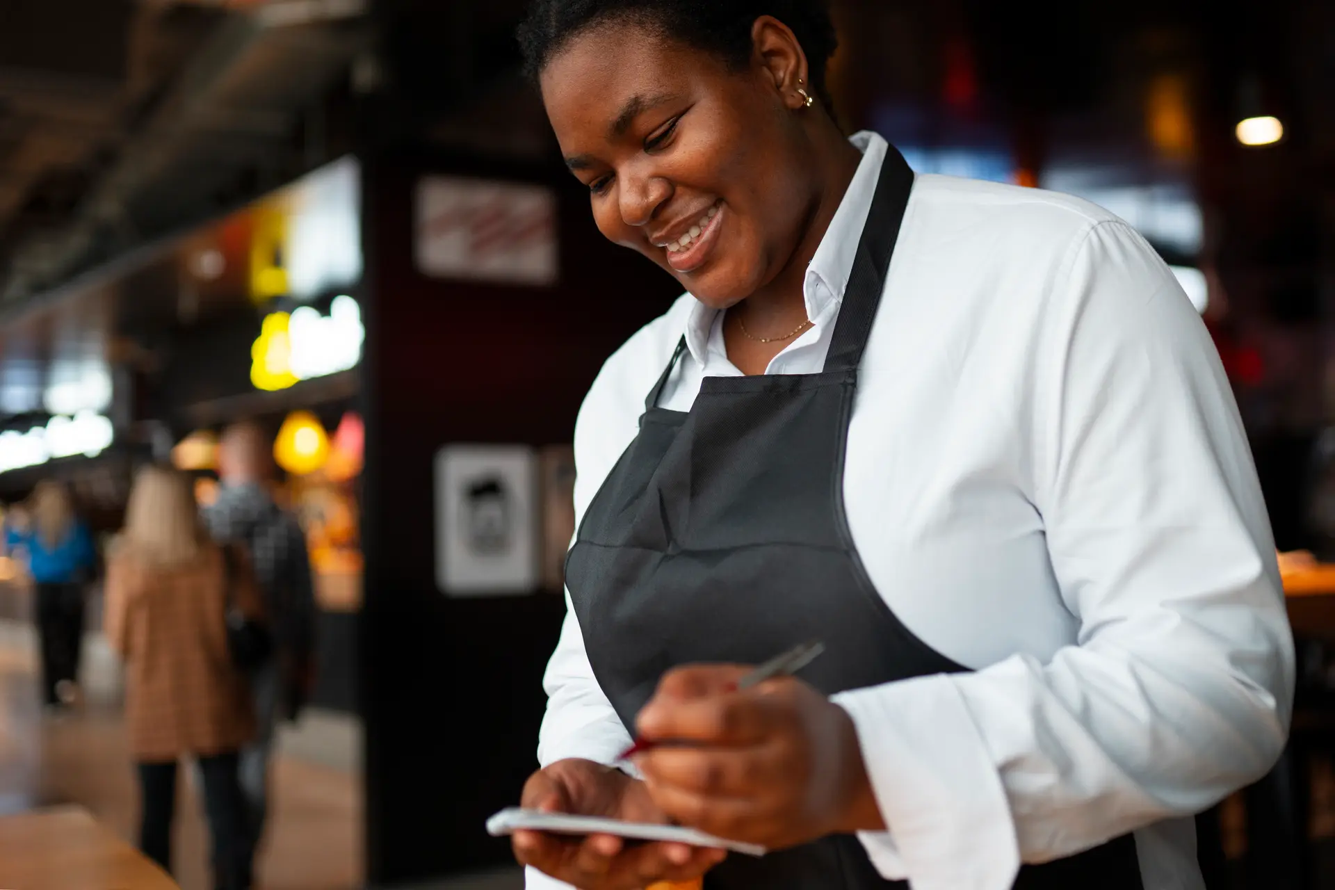 Staff member taking a table order on the floor